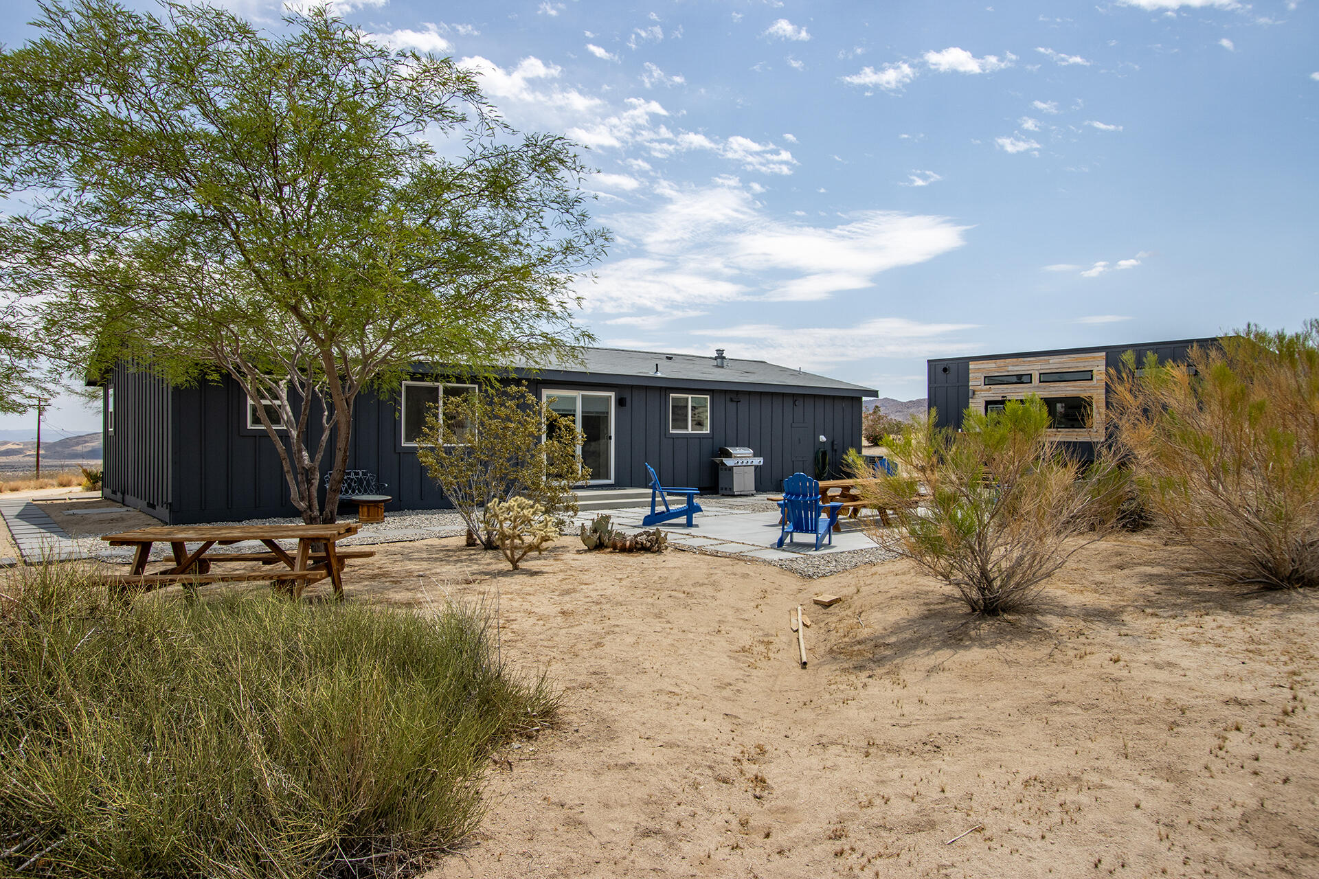 7122 Sunkist Road Joshua Tree, CA 92252 - Photo 49 of 61 a view of a house with backyard porch and sitting area