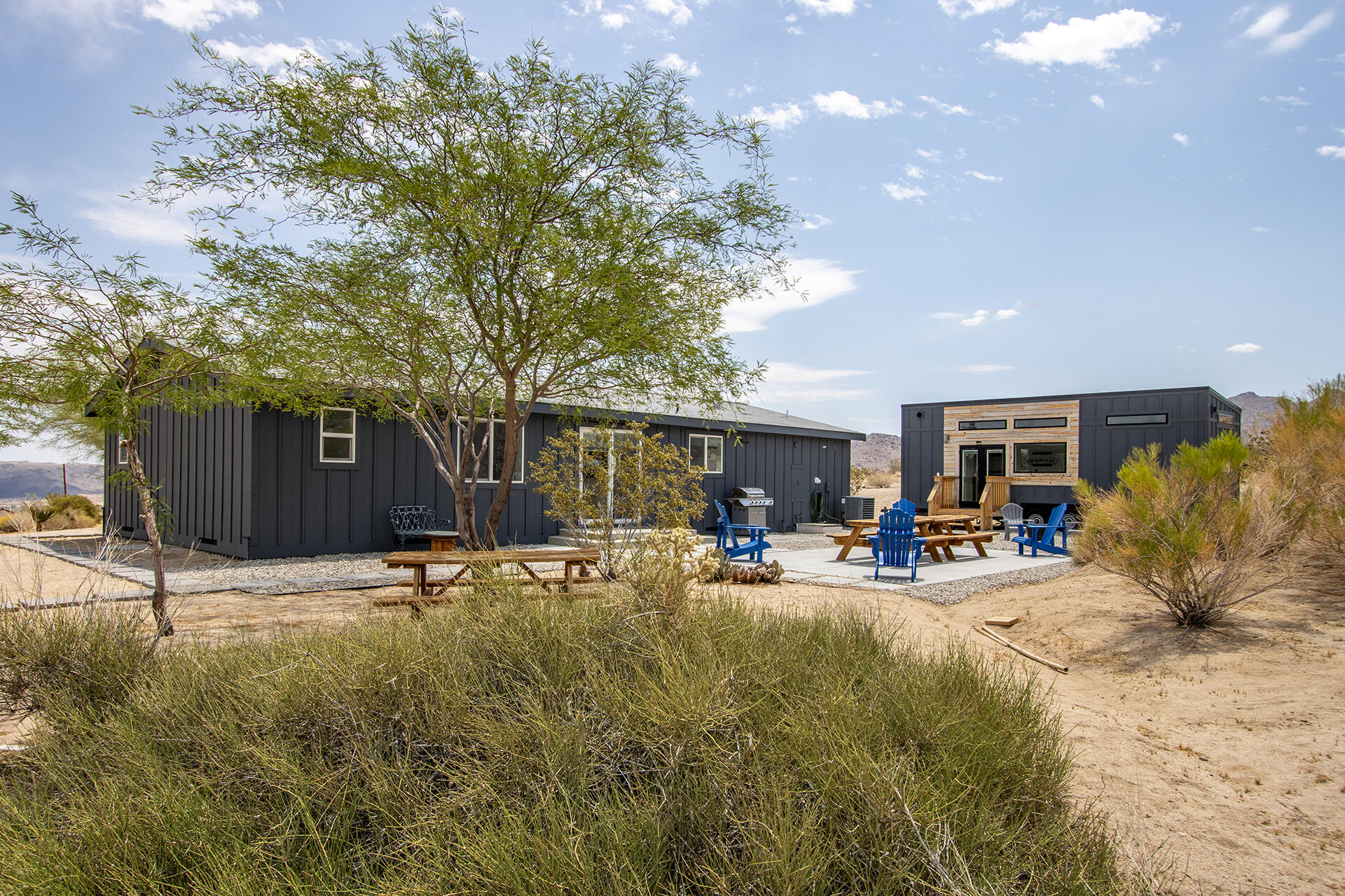7122 Sunkist Road Joshua Tree, CA 92252 - Photo 50 of 61 a backyard of a house with yard and outdoor seating