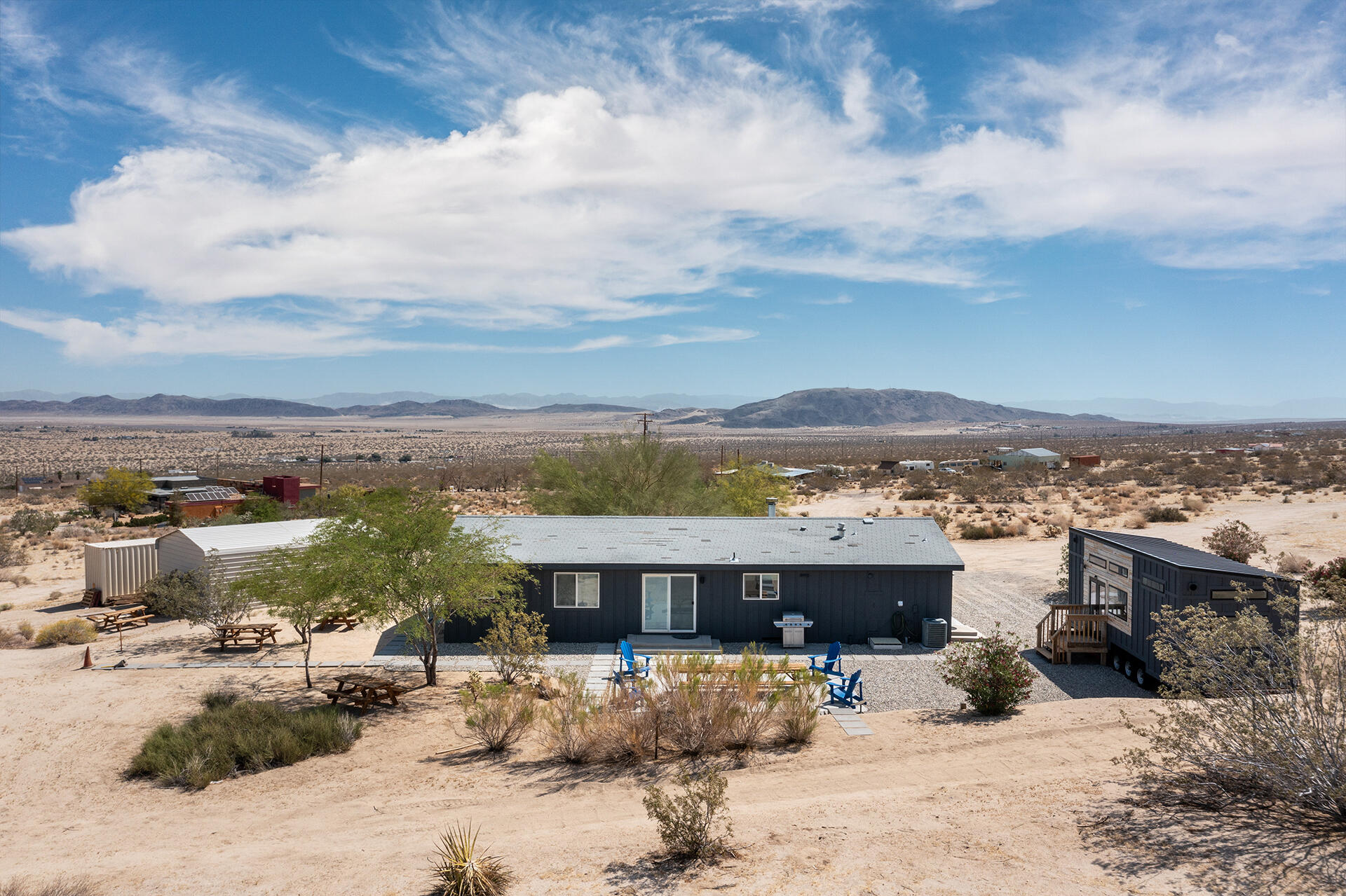 7122 Sunkist Road Joshua Tree, CA 92252 - Photo 7 of 61 a view of a terrace with lawn chairs