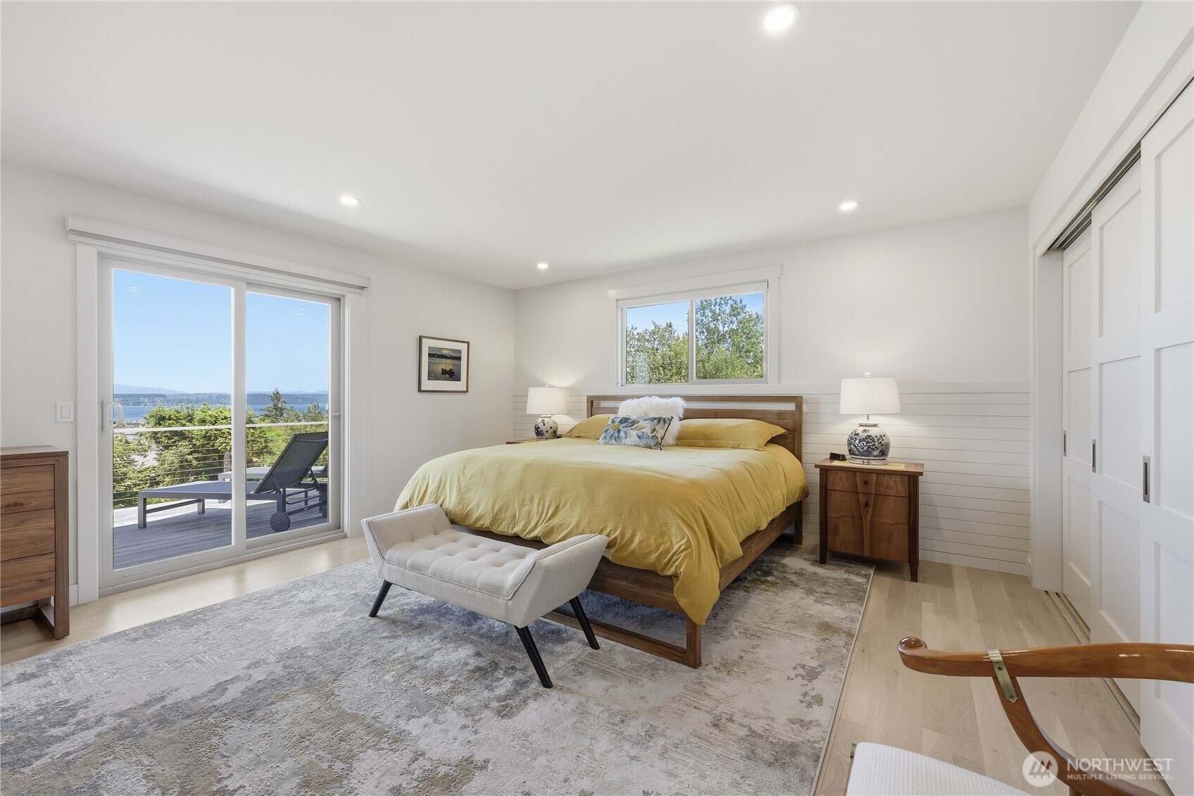 37709 Olympic View Road Northeast Hansville, WA 98340 - Photo 18 of 40 a spacious bedroom with a bed and large window