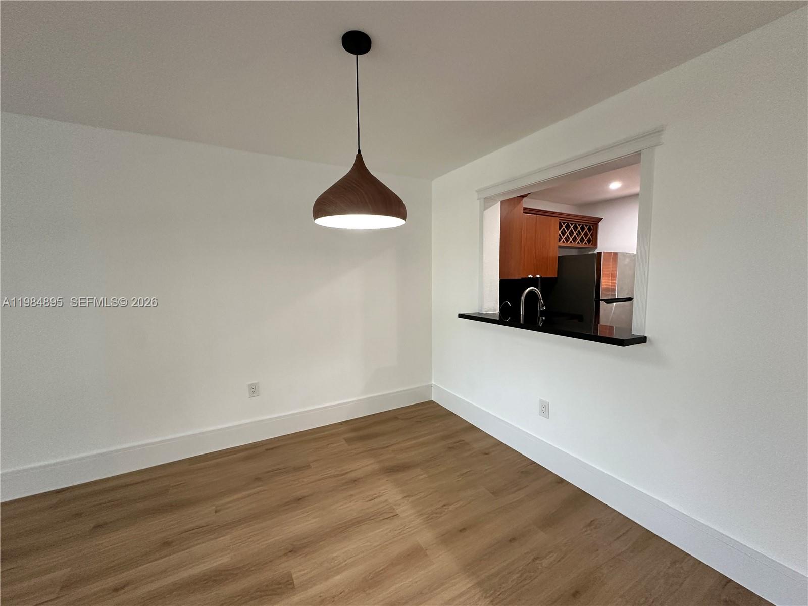 10425 Southwest 112th Avenue, Unit 324 Miami, FL 33176 - Photo 14 of 22 a view of a room with a chandelier fan and wooden floor