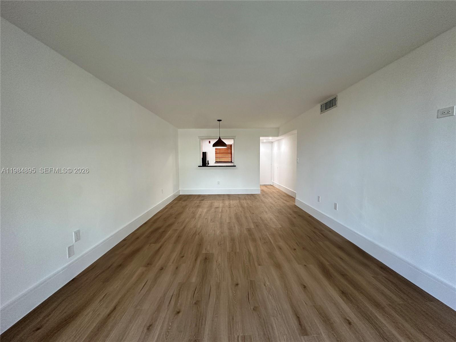 10425 Southwest 112th Avenue, Unit 324 Miami, FL 33176 - Photo 2 of 22 a view of a big room with wooden floor and windows