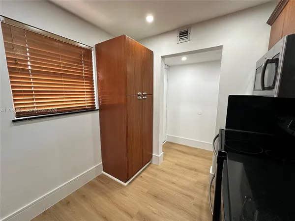 a view of hallway with wooden floor