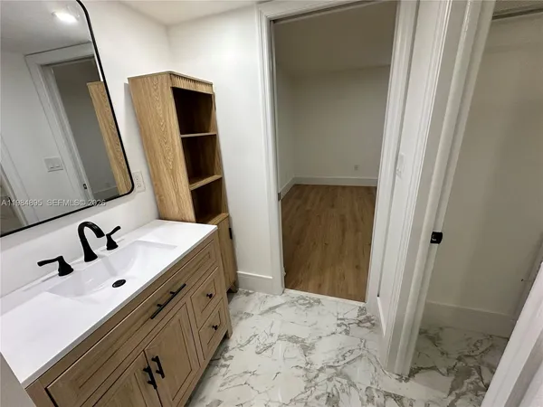 a bathroom with a double vanity sink and mirror