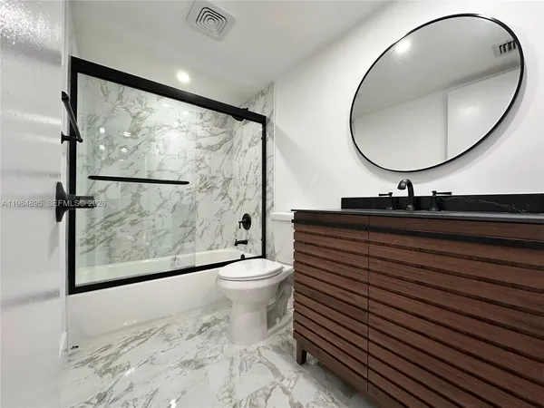 a bathroom with a sink a mirror and a toilet