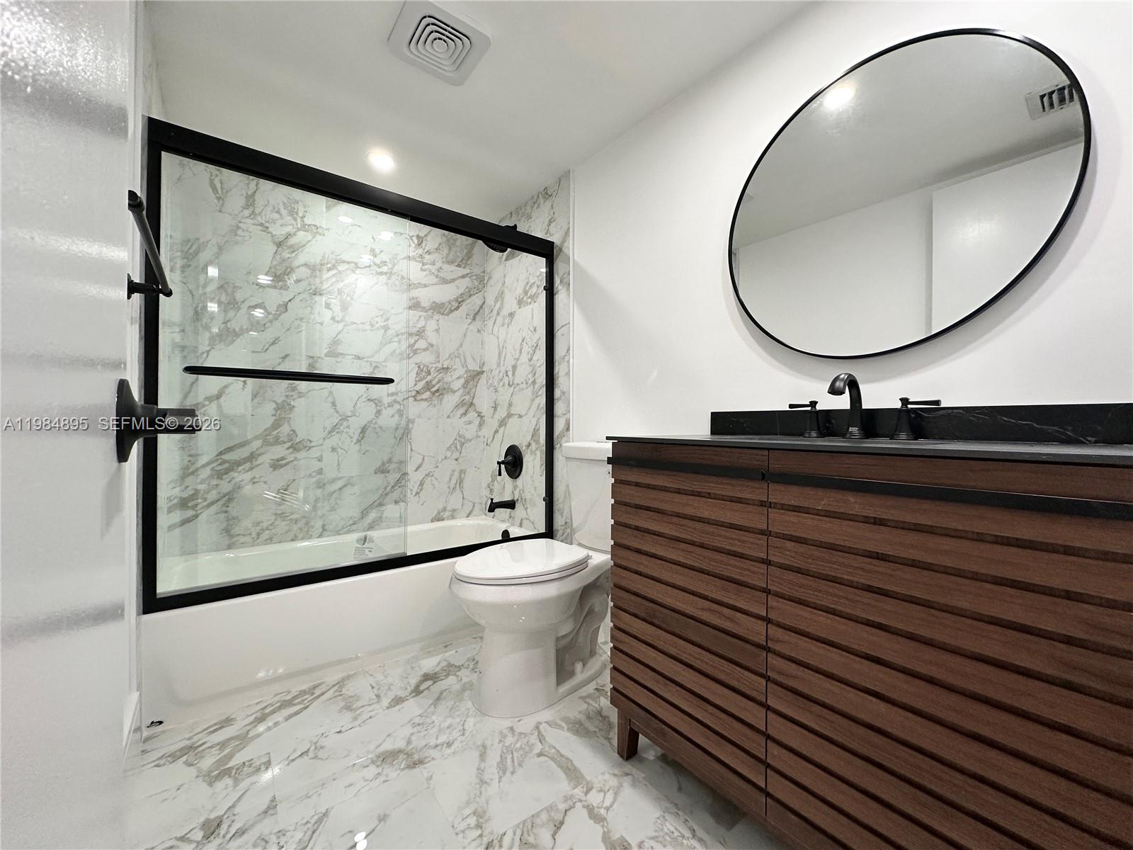 10425 Southwest 112th Avenue, Unit 324 Miami, FL 33176 - Photo 10 of 22 a bathroom with a sink a mirror and a toilet