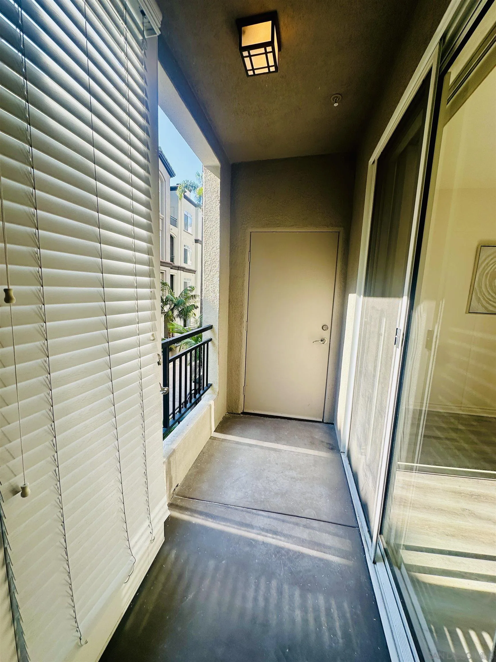 9263 Regents Road, Unit B204 La Jolla, CA 92037 - Photo 15 of 17 a view of a porch with wooden floor and stairs