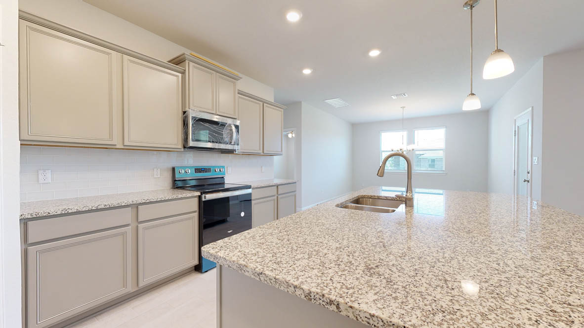 808 Gauge Road Thorndale, TX 76577 - Photo 5 of 31 Sleek granite countertops and stainless steel appliances define this contemporary culinary space.