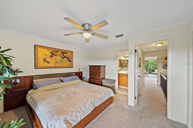 a bedroom with a large bed and a chandelier