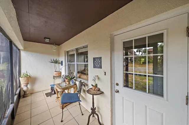 a balcony with furniture and a potted plant