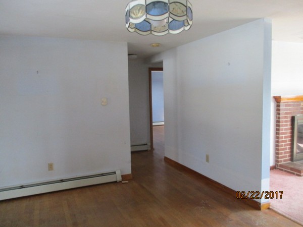 98 Jackson Road Hardwick, MA 01037 - Photo 5 of 18 an empty room with a fireplace