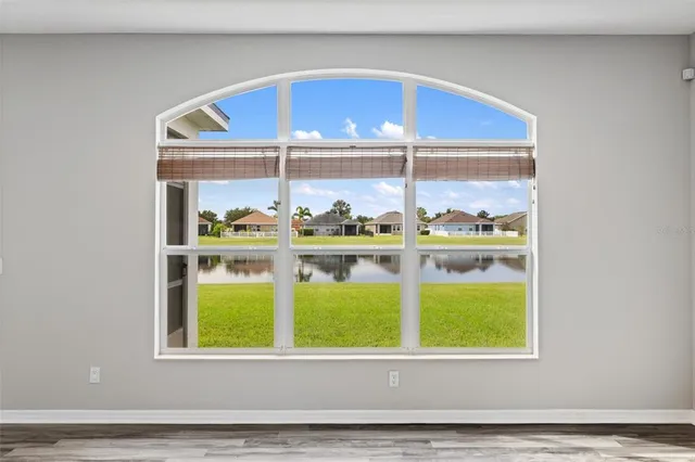 a large kitchen with stainless steel appliances kitchen island a large counter top and wooden floors