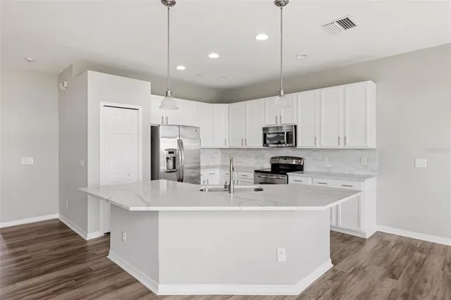 a spacious bathroom with a double vanity sink mirror and shower