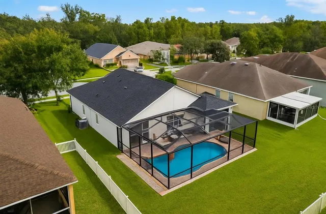 an aerial view of a house with a big yard