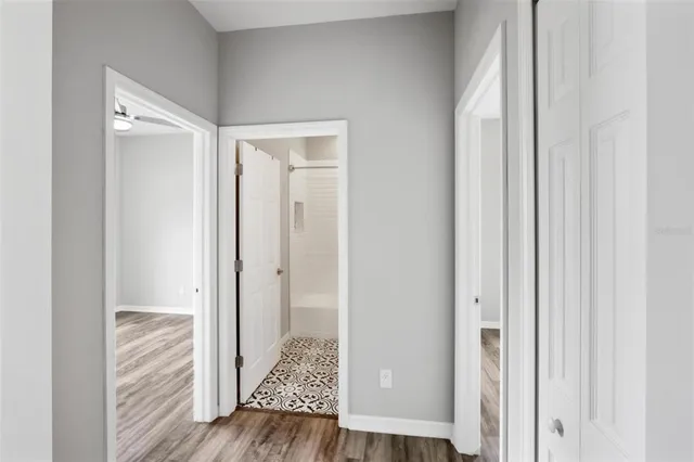 an aerial view of residential houses with outdoor space and trees