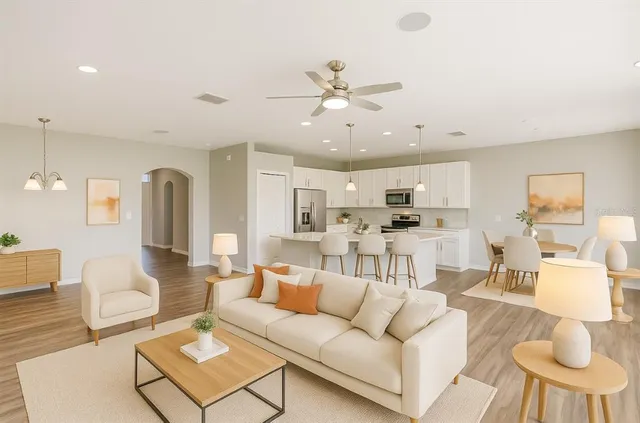 a kitchen with kitchen island white cabinets and stainless steel appliances