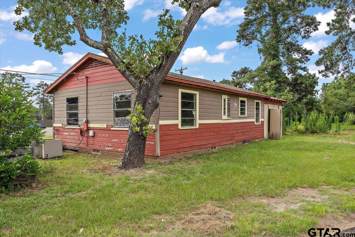 1535 North Dickinson Drive Rusk, TX 75785 - Photo 13 of 18 a front view of a house with a garden and trees