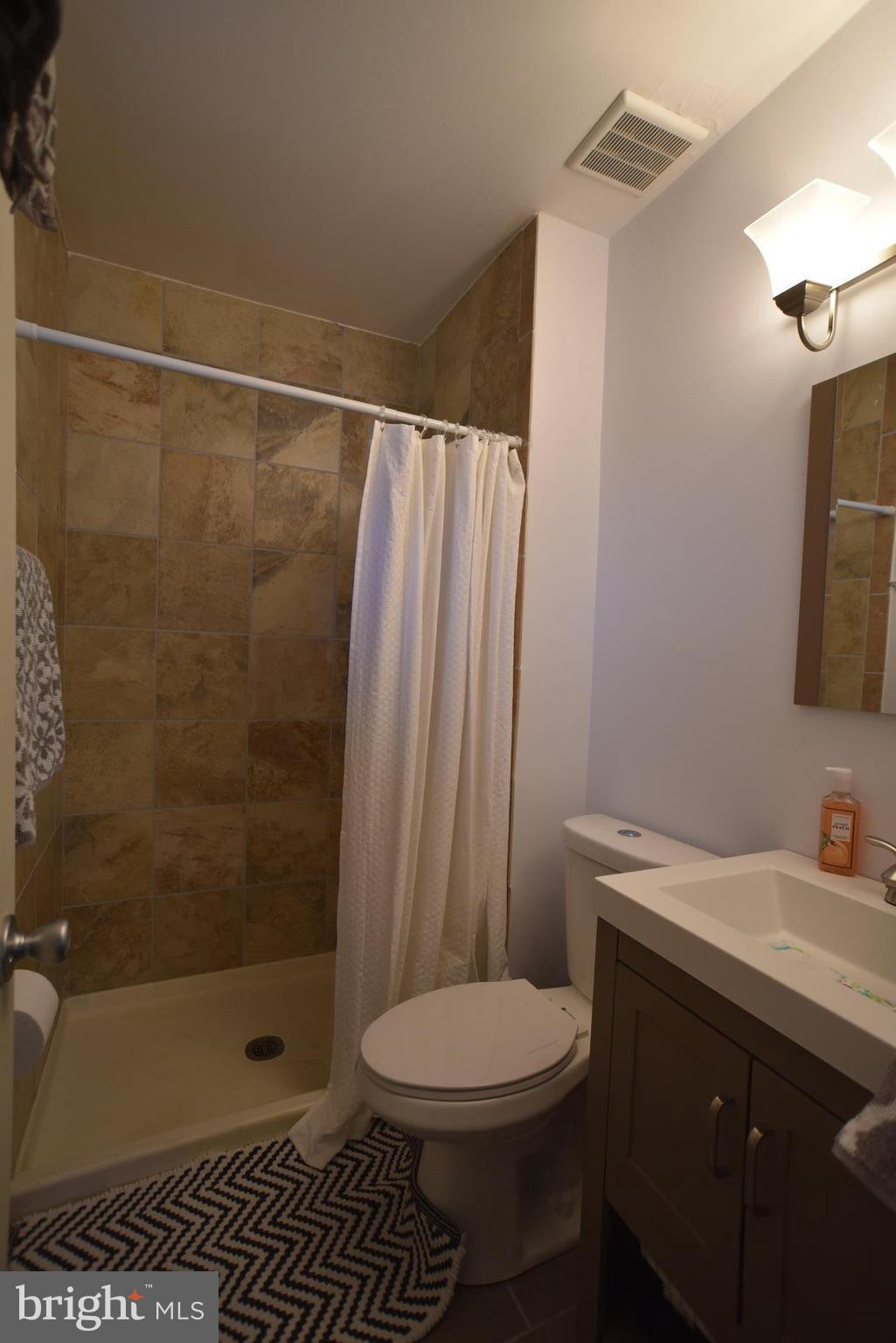 8645 Victoria Road Springfield, VA 22151 - Photo 11 of 19 a bathroom with a sink a toilet and shower