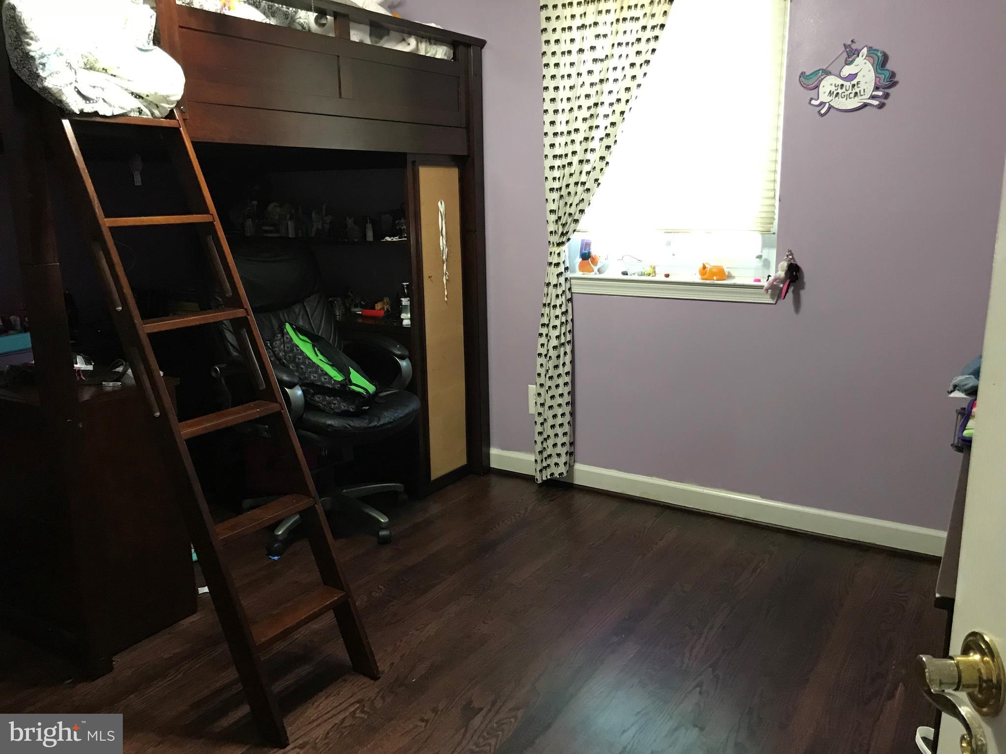 8645 Victoria Road Springfield, VA 22151 - Photo 12 of 19 an empty room with wooden floor and windows