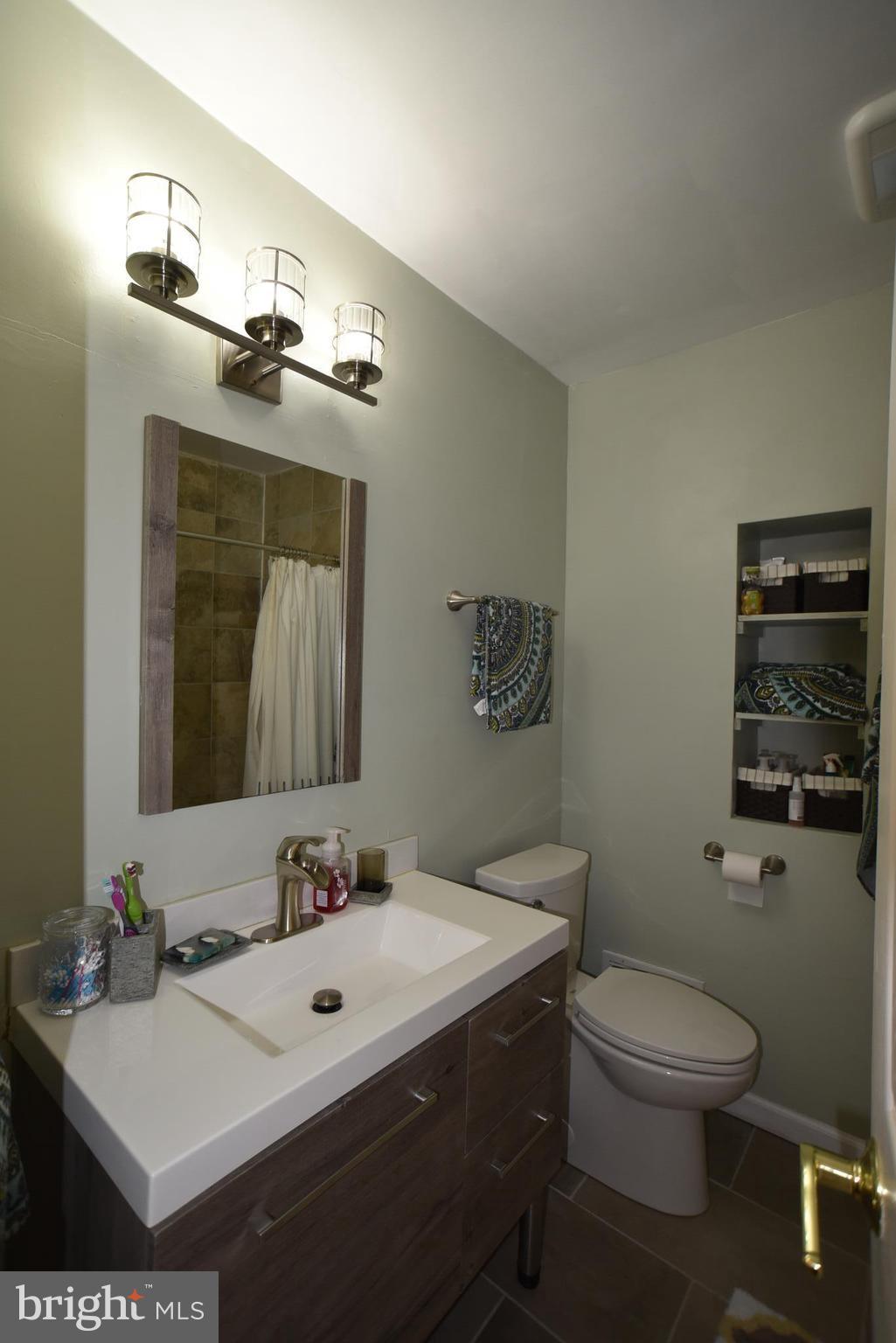 8645 Victoria Road Springfield, VA 22151 - Photo 15 of 19 a bathroom with a sink vanity mirror and toilet