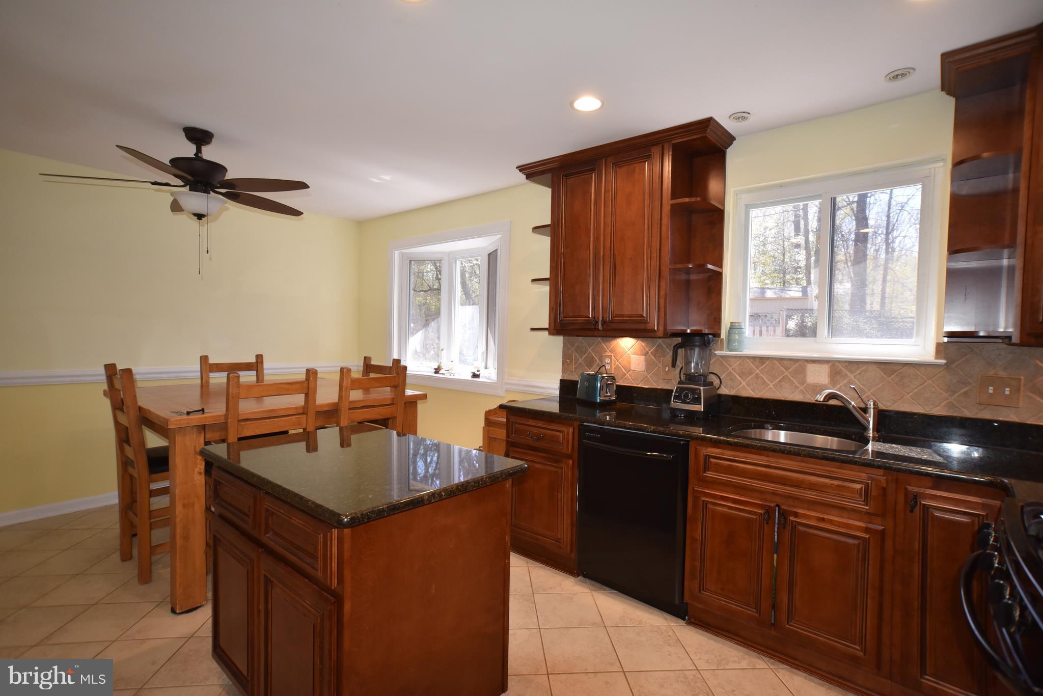 8645 Victoria Road Springfield, VA 22151 - Photo 4 of 19 a kitchen with a sink stove and microwave
