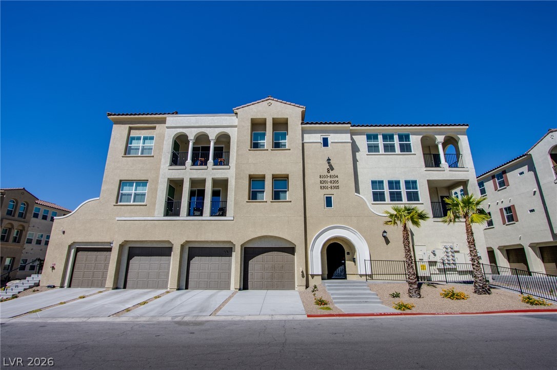 2555 Hampton Road, Unit 8201 Henderson, NV 89052 - Photo 8 of 33 Stately multi-level architecture stands out under clear blue skies with arched entries and integrated garages.