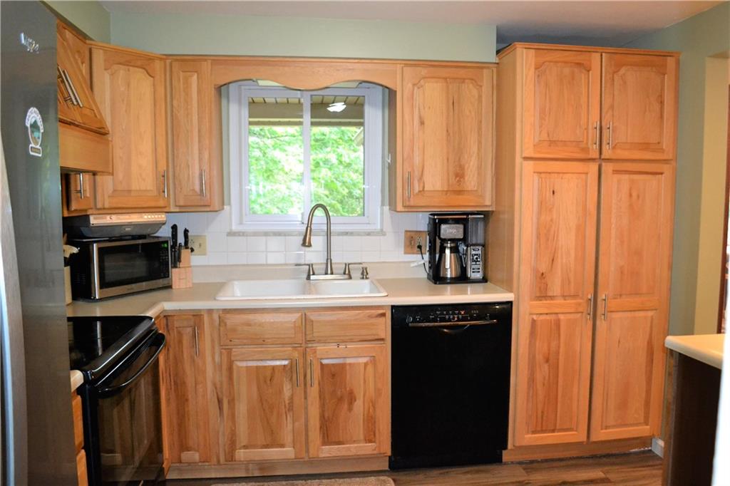 1129 Cheese Run Road Indiana, PA 15701 - Photo 7 of 25 a kitchen with stainless steel appliances granite countertop a refrigerator a sink dishwasher and wooden cabinets with wooden floor