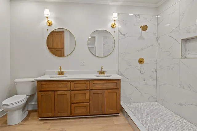 a bathroom with a toilet sink and mirror
