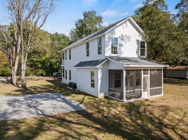 a view of a house with a yard covered in snow