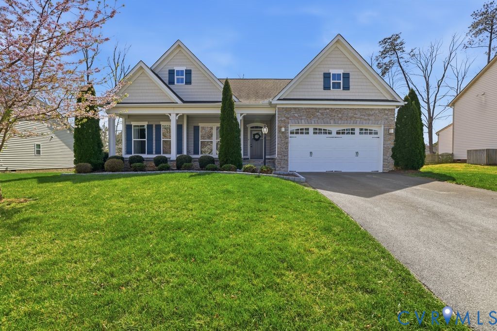 8712 Bailey Hill Road Midlothian, VA 23112 - Photo 1 of 46 a front view of a house with a yard and garage