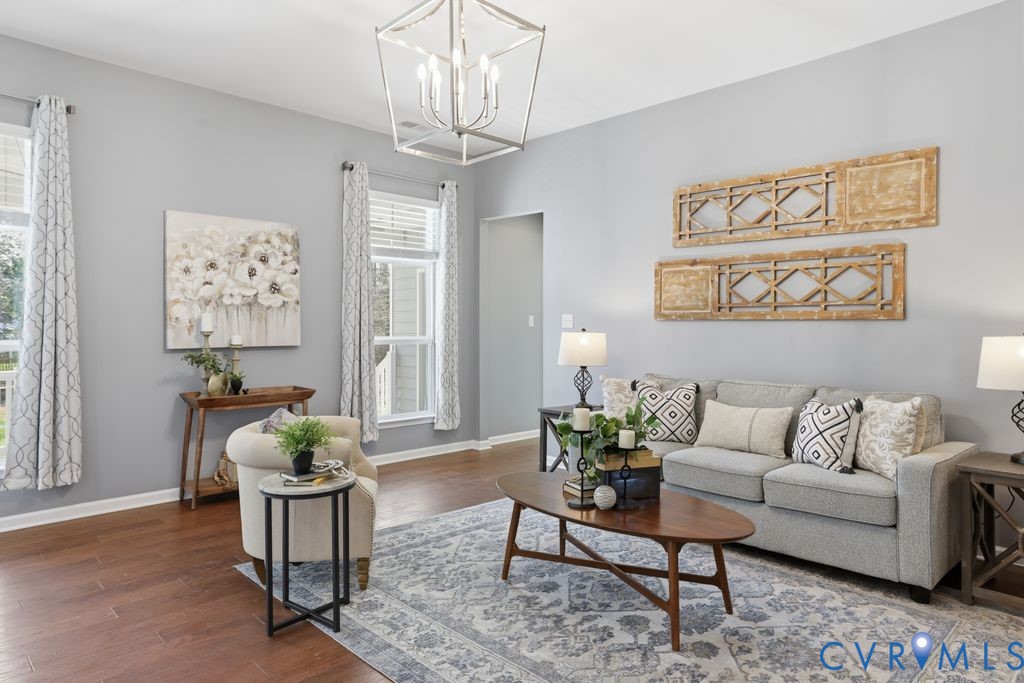 8712 Bailey Hill Road Midlothian, VA 23112 - Photo 11 of 46 a living room with furniture and a chandelier