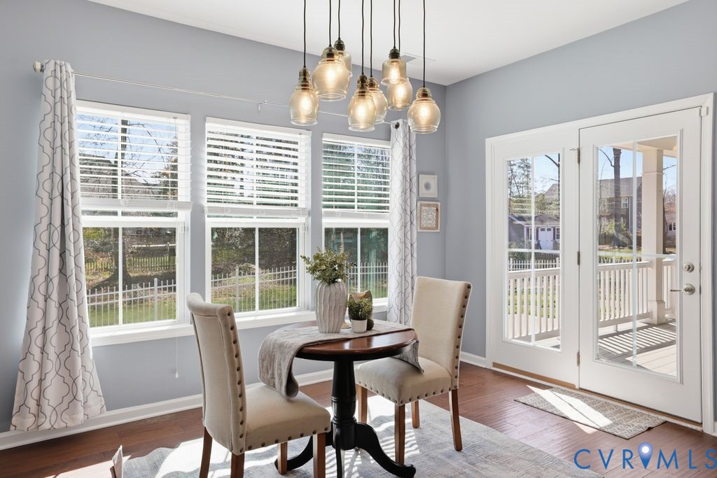 8712 Bailey Hill Road Midlothian, VA 23112 - Photo 19 of 46 a dining room with furniture a chandelier and wooden floor