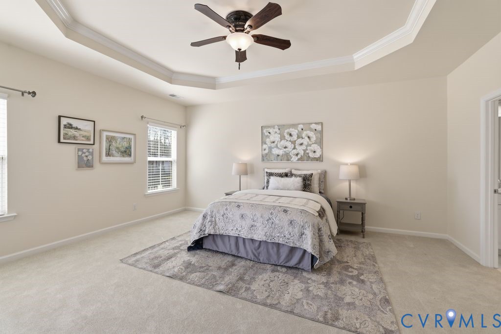 8712 Bailey Hill Road Midlothian, VA 23112 - Photo 21 of 46 a bedroom with a bed and a chandelier