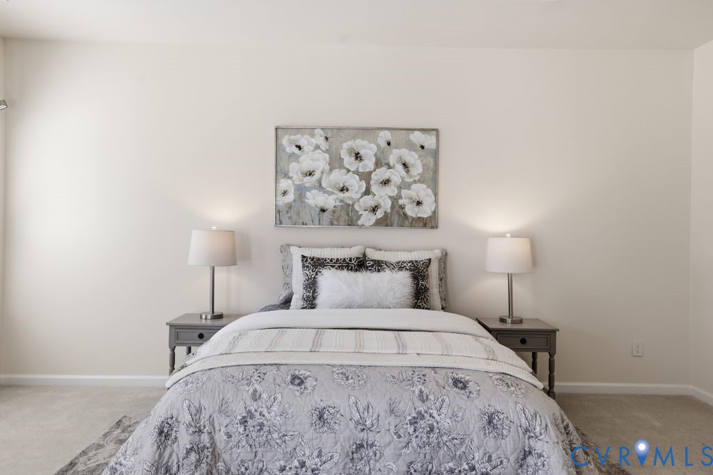8712 Bailey Hill Road Midlothian, VA 23112 - Photo 22 of 46 a bedroom with a bed and a lamp