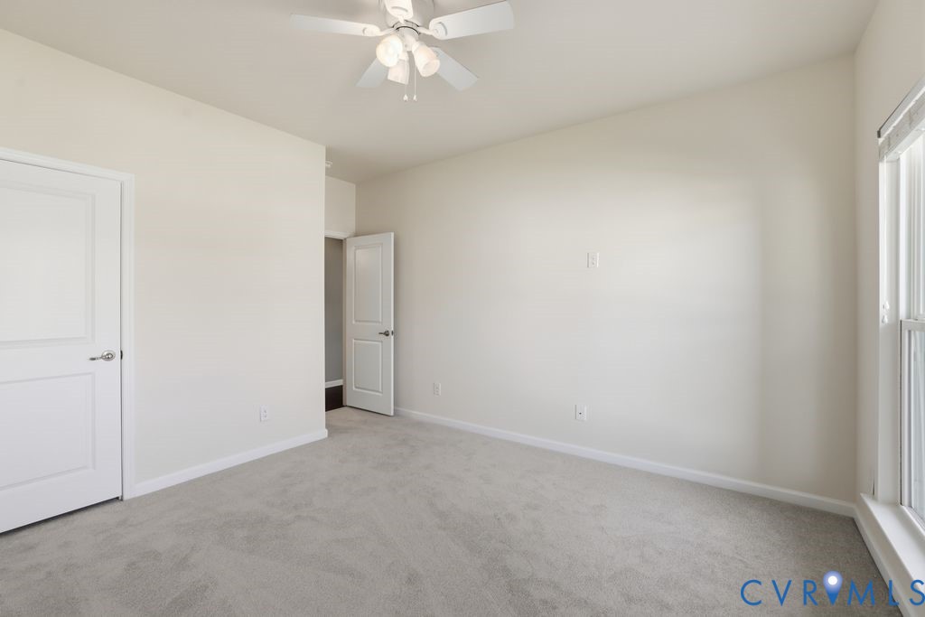 8712 Bailey Hill Road Midlothian, VA 23112 - Photo 30 of 46 an empty room with a ceiling fan and a window