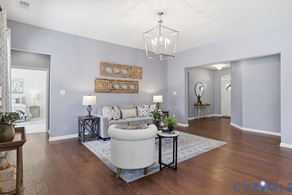 8712 Bailey Hill Road Midlothian, VA 23112 - Photo 10 of 46 a living room with furniture and a chandelier