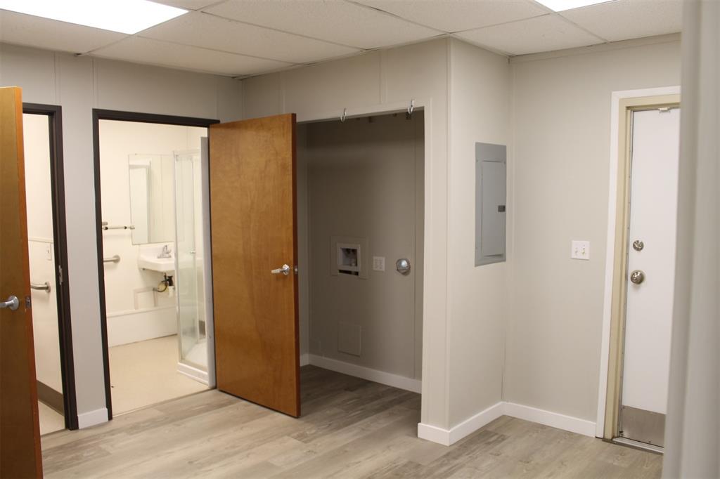 5259 Fm 156 Street North, Unit 6 Krum, TX 76249 - Photo 11 of 16 a view of a bathroom with a glass door and a bathroom