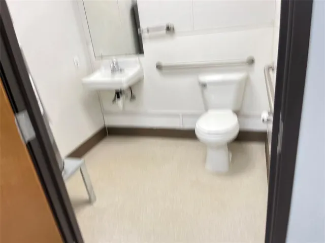 a bathroom with a sink a toilet and mirror