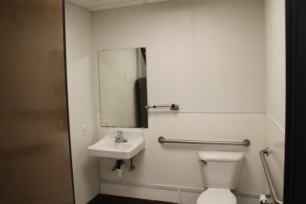 5259 Fm 156 Street North, Unit 6 Krum, TX 76249 - Photo 14 of 16 a bathroom with a sink a toilet and mirror