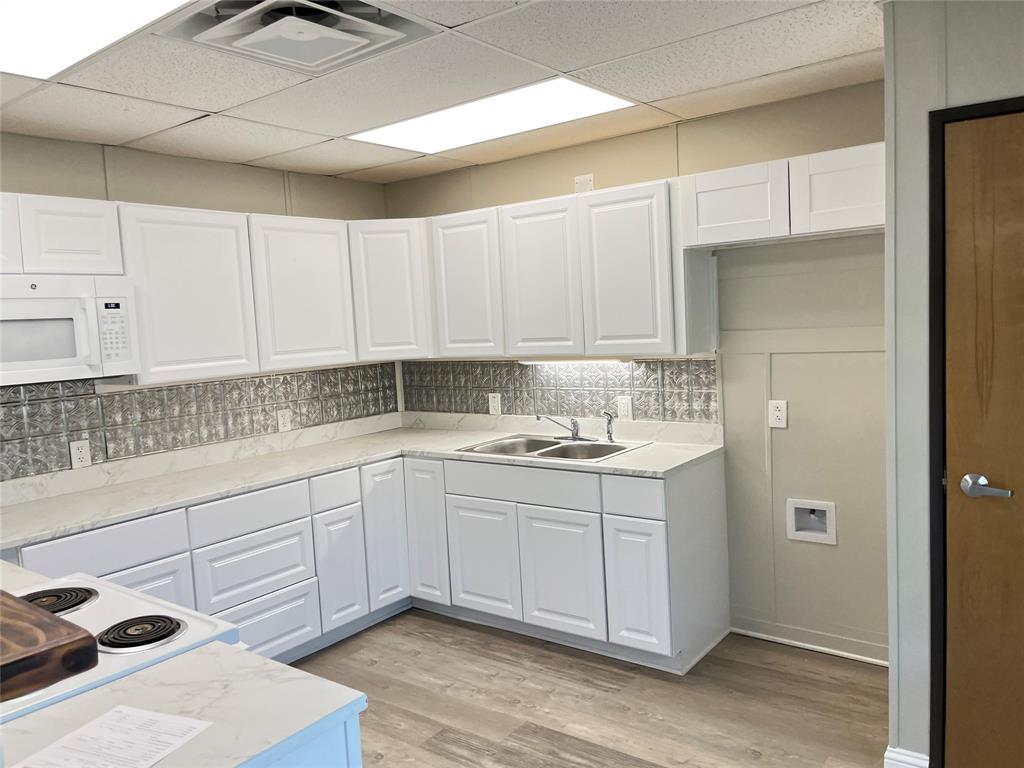 5259 Fm 156 Street North, Unit 6 Krum, TX 76249 - Photo 3 of 16 a kitchen with a sink and cabinets