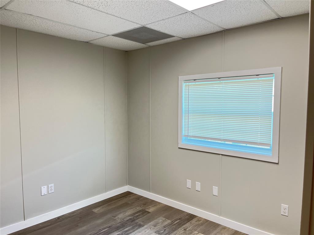 5259 Fm 156 Street North, Unit 6 Krum, TX 76249 - Photo 6 of 16 a view of a small space with wooden floor and a window