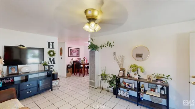 a living room with furniture a flat screen tv and a window