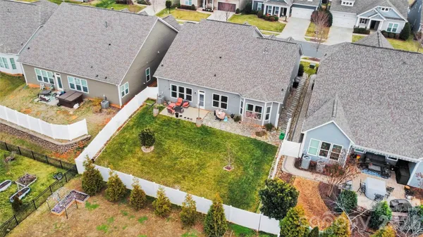 an aerial view of residential houses with outdoor space and swimming pool