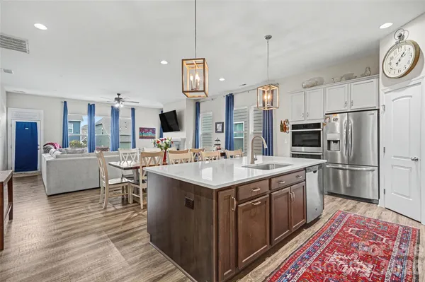 a kitchen with a sink refrigerator and cabinets