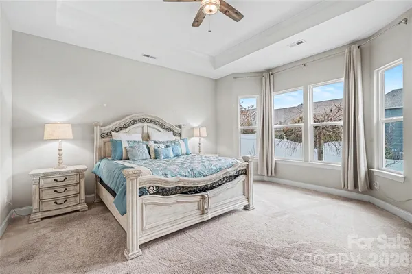 a bedroom with a bed a window and couch