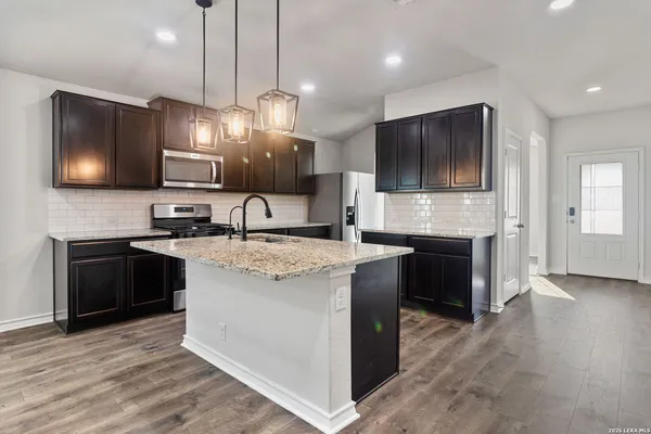 a kitchen with kitchen island granite countertop stainless steel appliances and a counter top space