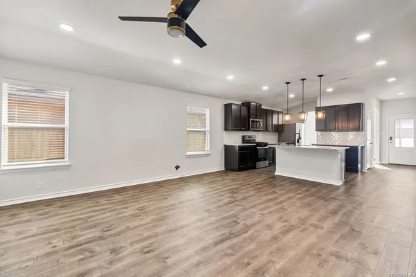 a view of a kitchen with a sink and a stove top oven