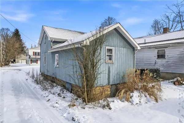 a view of a house with wooden fence