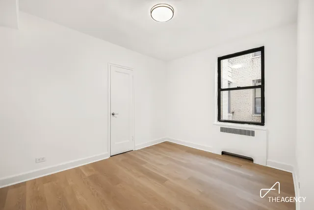 a bedroom with a bed and a potted plant