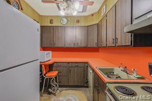 22 Middleville Road Northport, NY 11768 - Photo 11 of 20 Kitchen featuring white appliances, light countertops, and under cabinet range hood